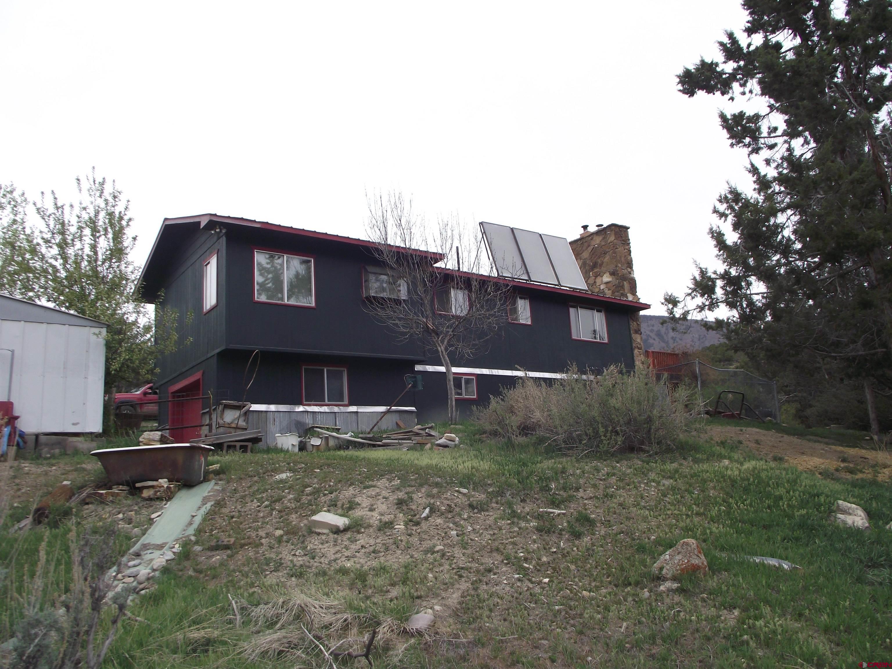 42996 Needle Rock Road Crawford, CO 81415 - Photo 18 of 45 a view of a house with a yard