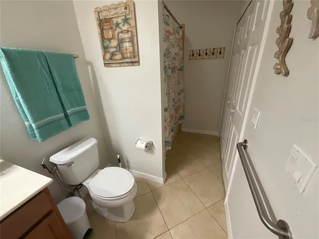 a white toilet sitting next to a shower curtain