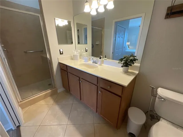 a bed room with a bed and a chair