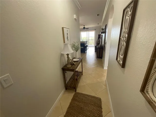 a living room with furniture a window and a chandelier