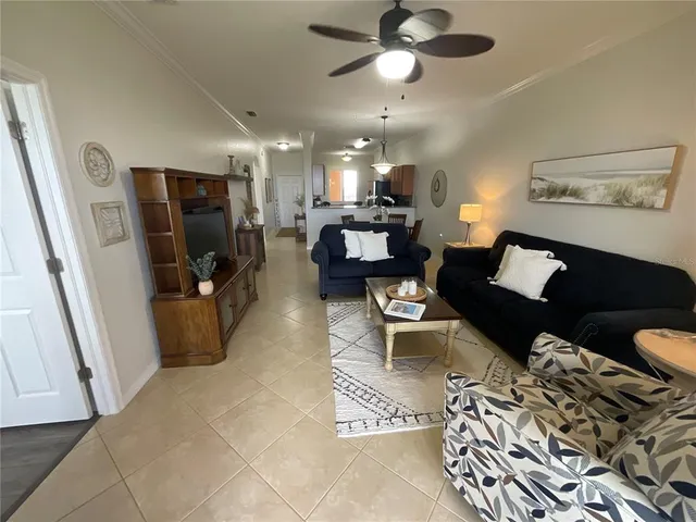 a living room with dining table and chairs