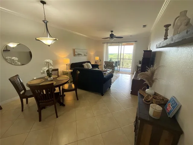 a living room with furniture a window and a chandelier