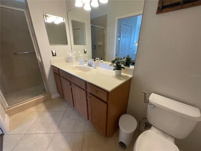 a view of a refrigerator in kitchen and utility room