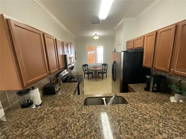 an aerial view of ocean and residential houses with outdoor space