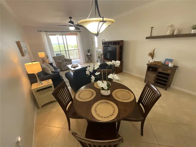 a dining room with furniture and a chandelier