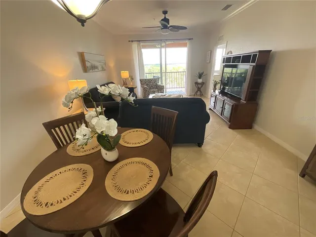 a dining room with furniture a rug and wooden floor