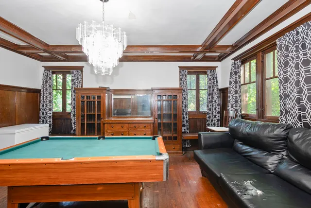 a living room with fireplace furniture and a chandelier