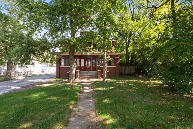 a view of a house with backyard and sitting area