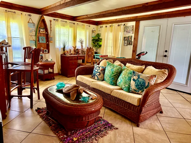 a living room with furniture and a potted plant