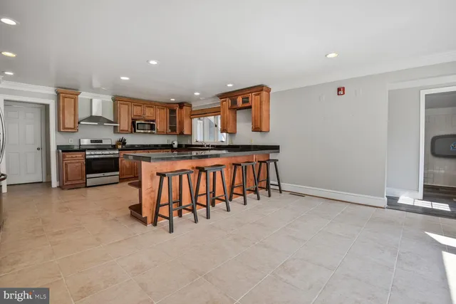 a kitchen with stainless steel appliances granite countertop a stove and a refrigerator