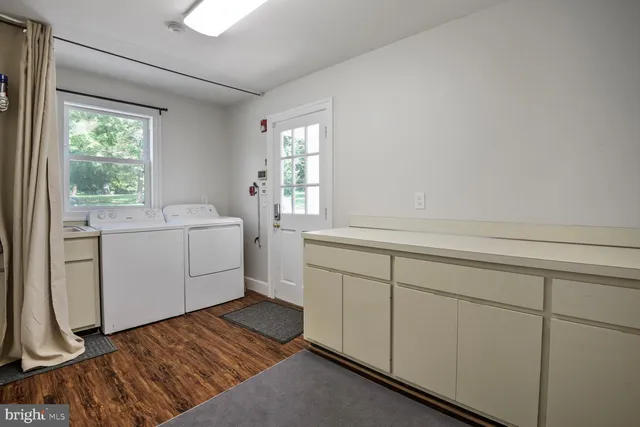 a room with a sink a window and a mirror