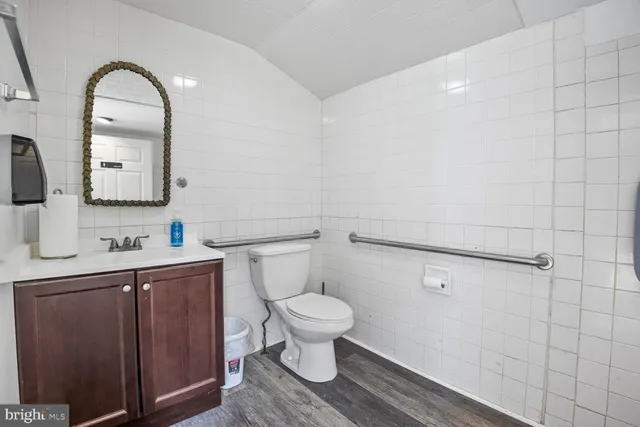 a bathroom with a toilet sink and mirror