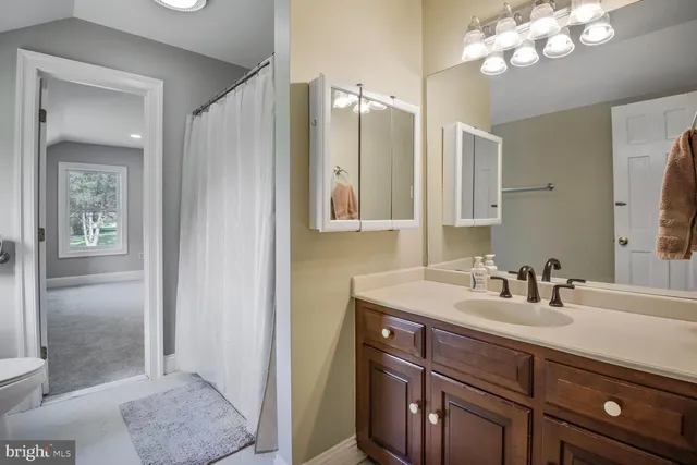 a view of a house with a patio and a yard