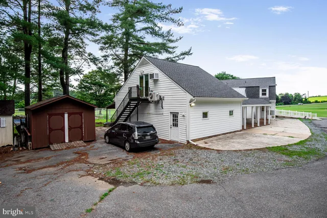 a kitchen with a table chairs sink and cabinets