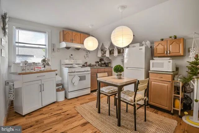 a view of a room with wooden floor and a window