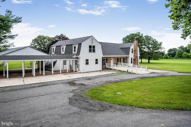 a front view of a house with a yard table and chairs