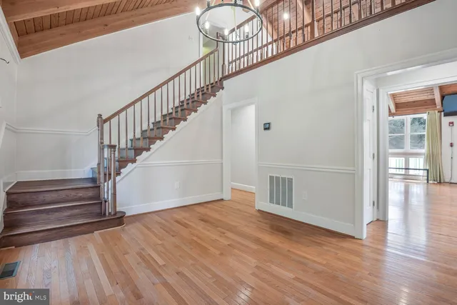 a view of entryway and hall with wooden floor