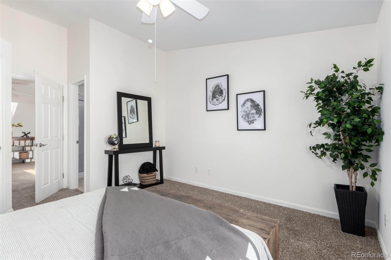 1885 South Quebec Way, Unit B22 Denver, CO 80231 - Photo 23 of 47 a bedroom with a bed and a potted plant