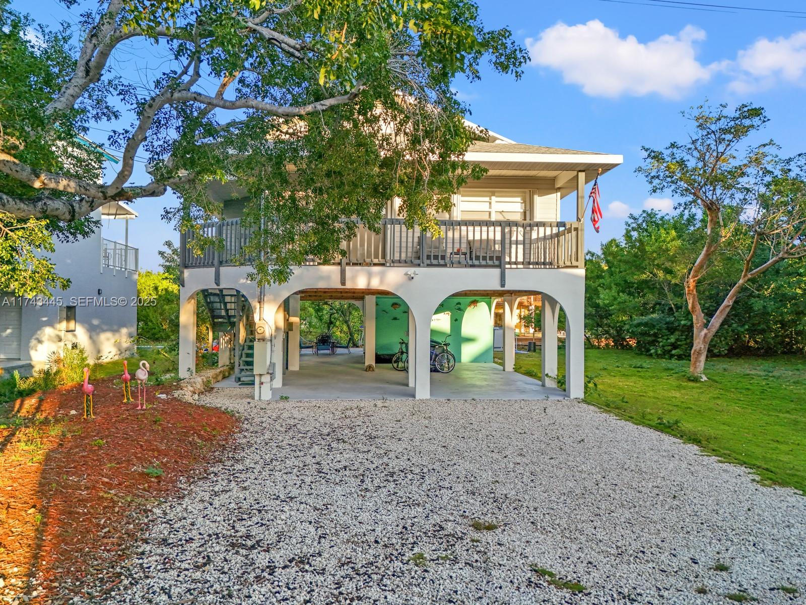 3635 Tradewinds Street Big Pine Key, FL 33043 - Photo 1 of 41 a front view of a house with garden