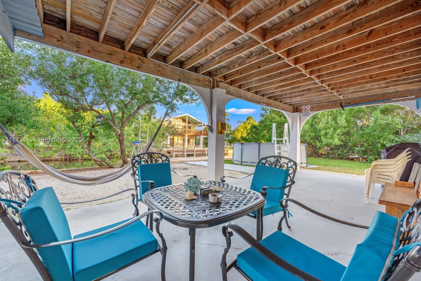 3635 Tradewinds Street Big Pine Key, FL 33043 - Photo 12 of 41 a view of a porch with furniture and a yard