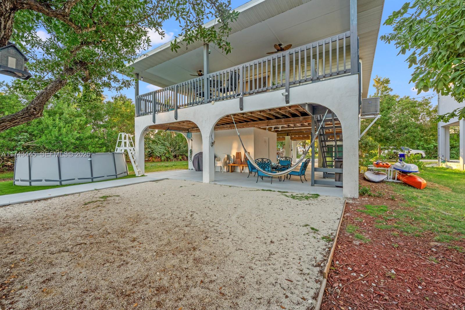 3635 Tradewinds Street Big Pine Key, FL 33043 - Photo 13 of 41 a view of a house with a yard and a car