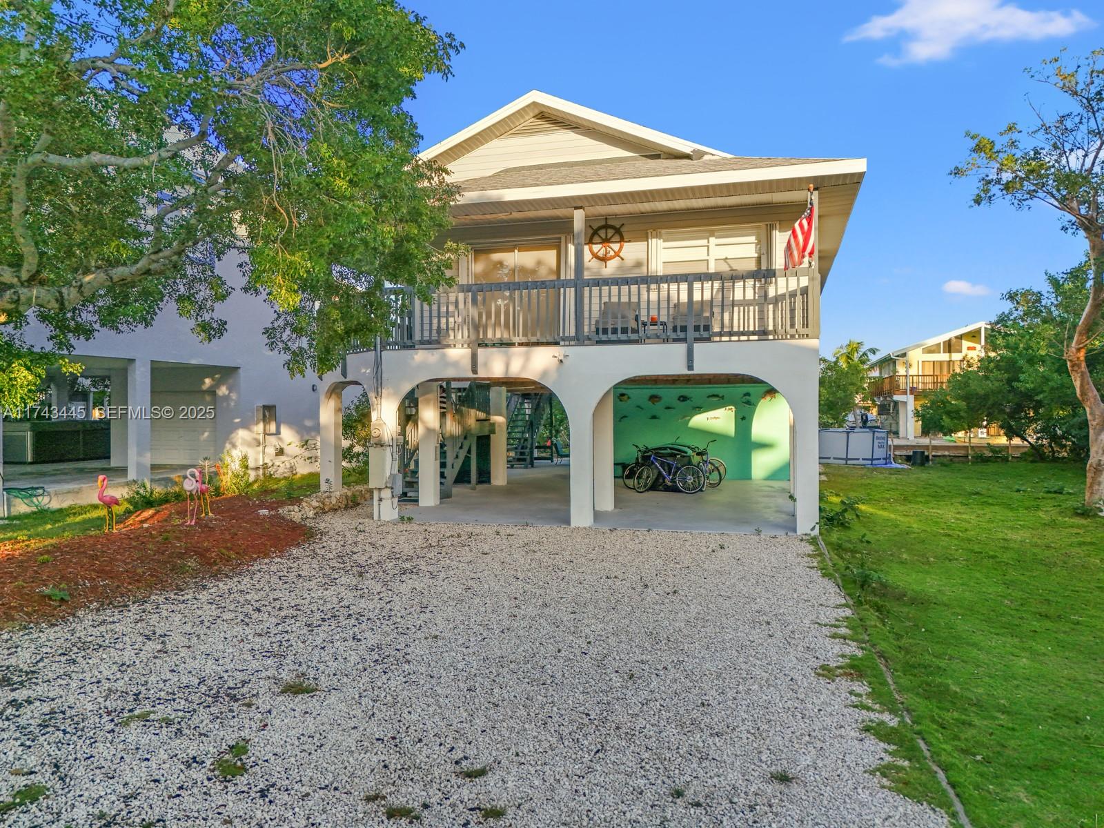 3635 Tradewinds Street Big Pine Key, FL 33043 - Photo 2 of 41 a front view of a house with garden
