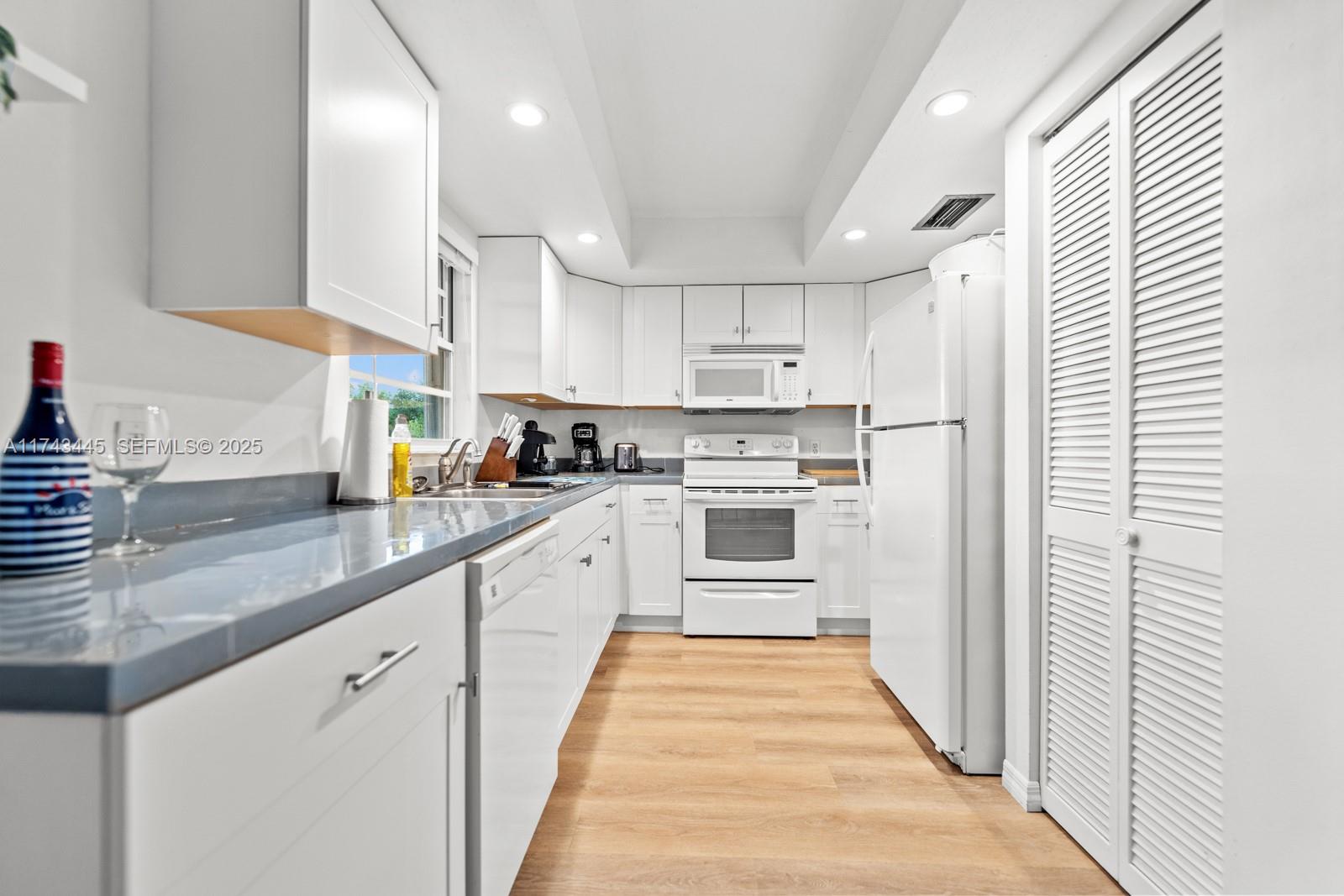 3635 Tradewinds Street Big Pine Key, FL 33043 - Photo 23 of 41 a kitchen with white cabinets appliances and sink