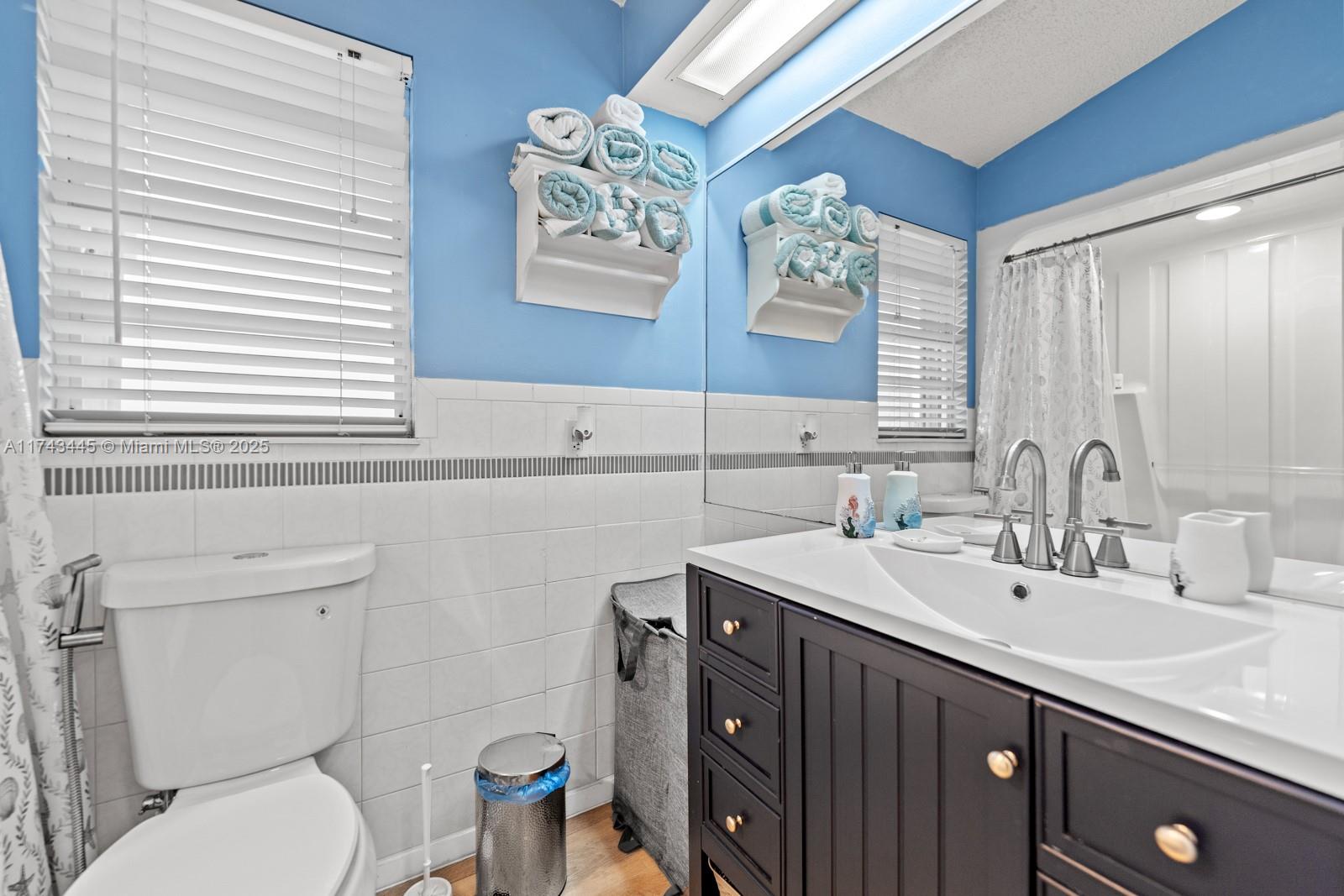 3635 Tradewinds Street Big Pine Key, FL 33043 - Photo 30 of 41 a bathroom with a sink a toilet a mirror and a window