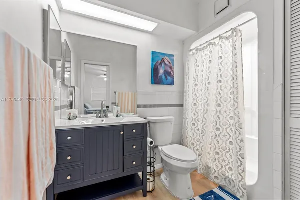 a bathroom with a toilet a sink and a mirror