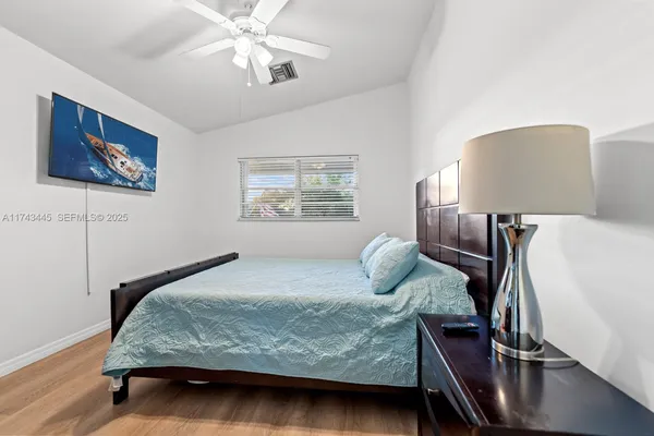 a bedroom with a bed and lamp