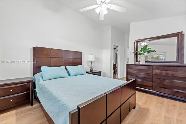 a bedroom with a large bed and a dresser