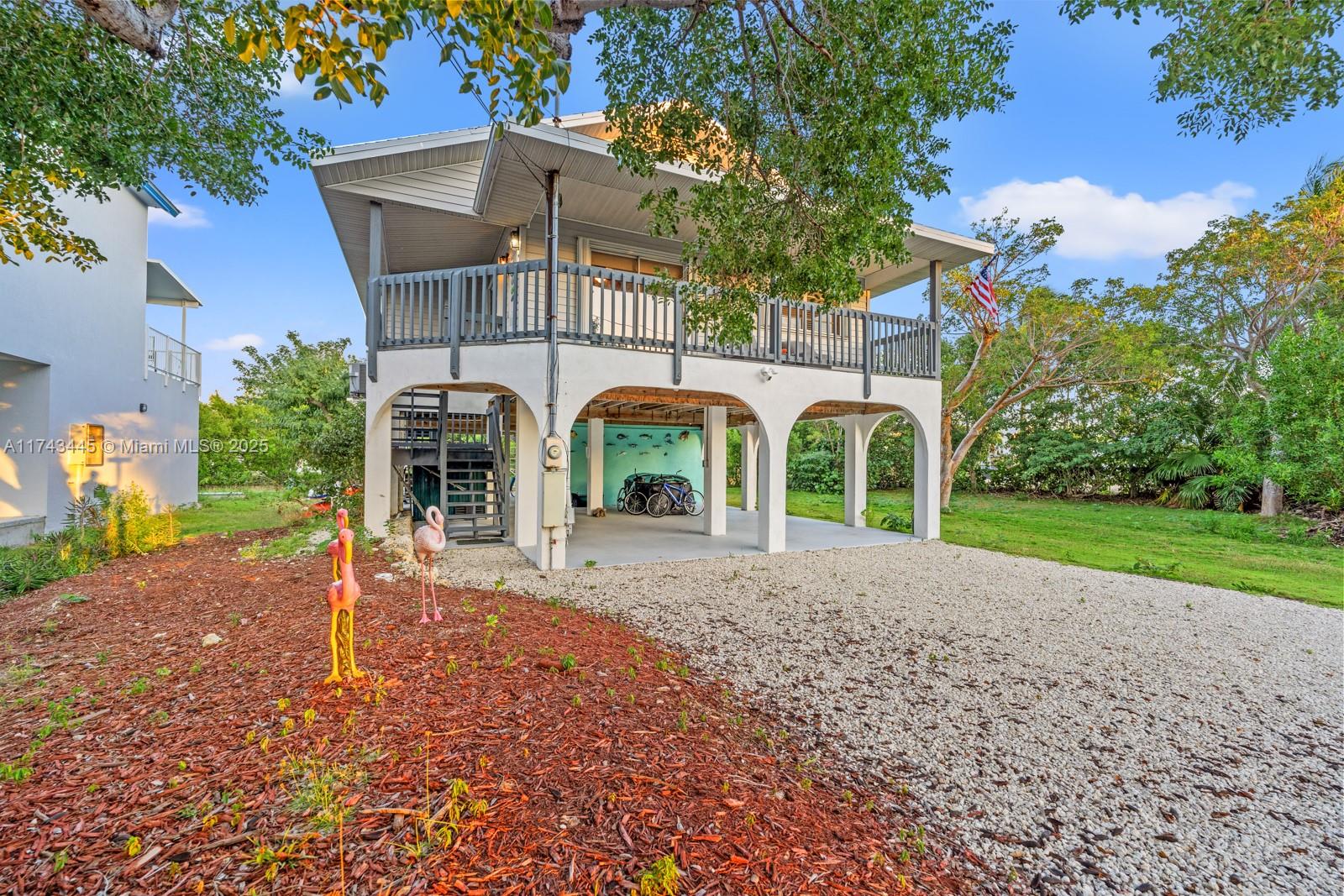 3635 Tradewinds Street Big Pine Key, FL 33043 - Photo 41 of 41 a view of a brick house with a yard and plants