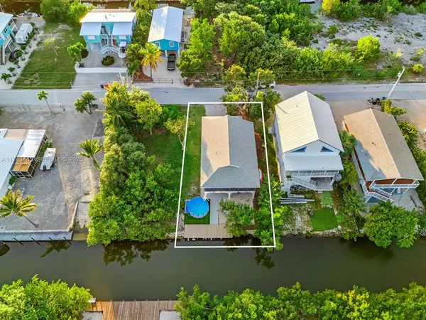 an aerial view of a house with a lake view