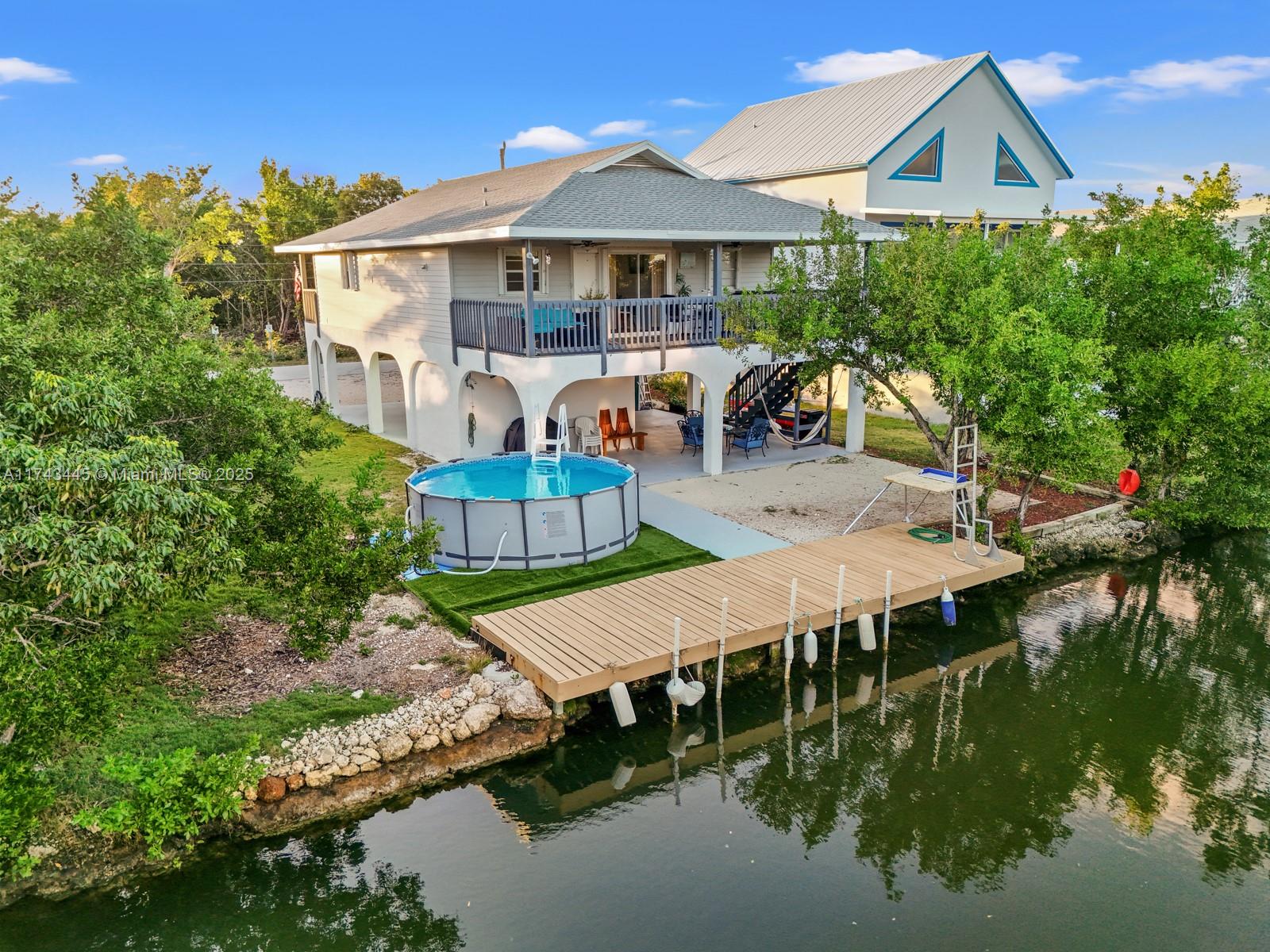 3635 Tradewinds Street Big Pine Key, FL 33043 - Photo 9 of 41 a view of a house with pool and chairs