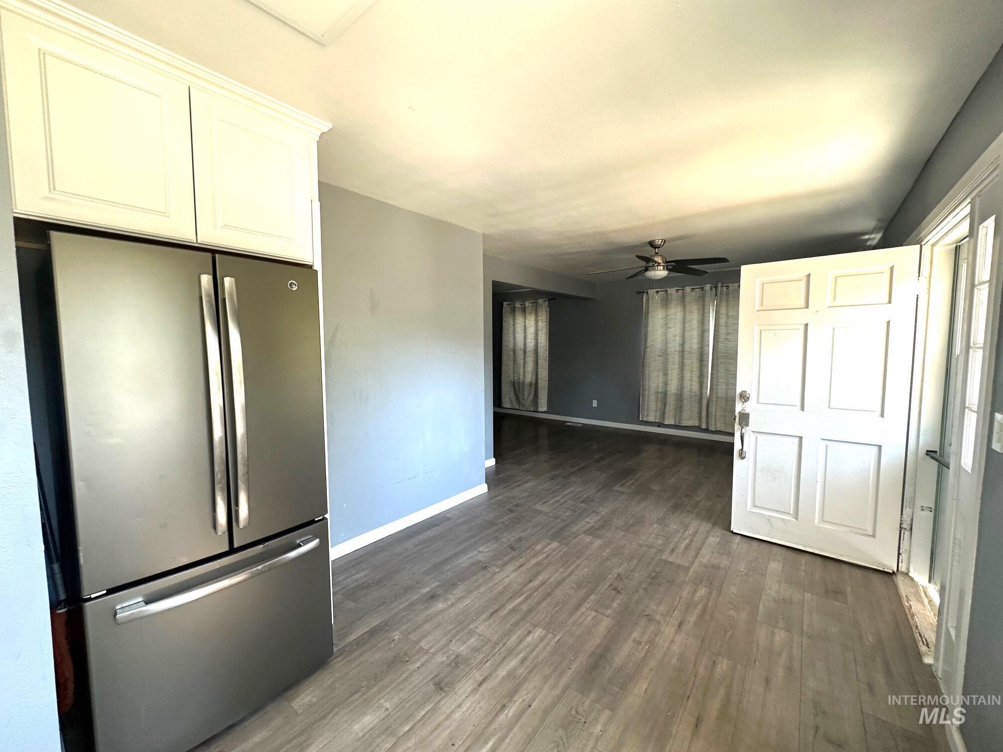 787 Southwest 3rd Street Ontario, OR 97914 - Photo 6 of 22 Unfurnished living room with dark wood-style floors and a ceiling fan
