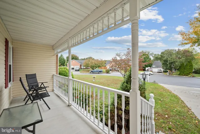 a view of a chair and tables in the balcony