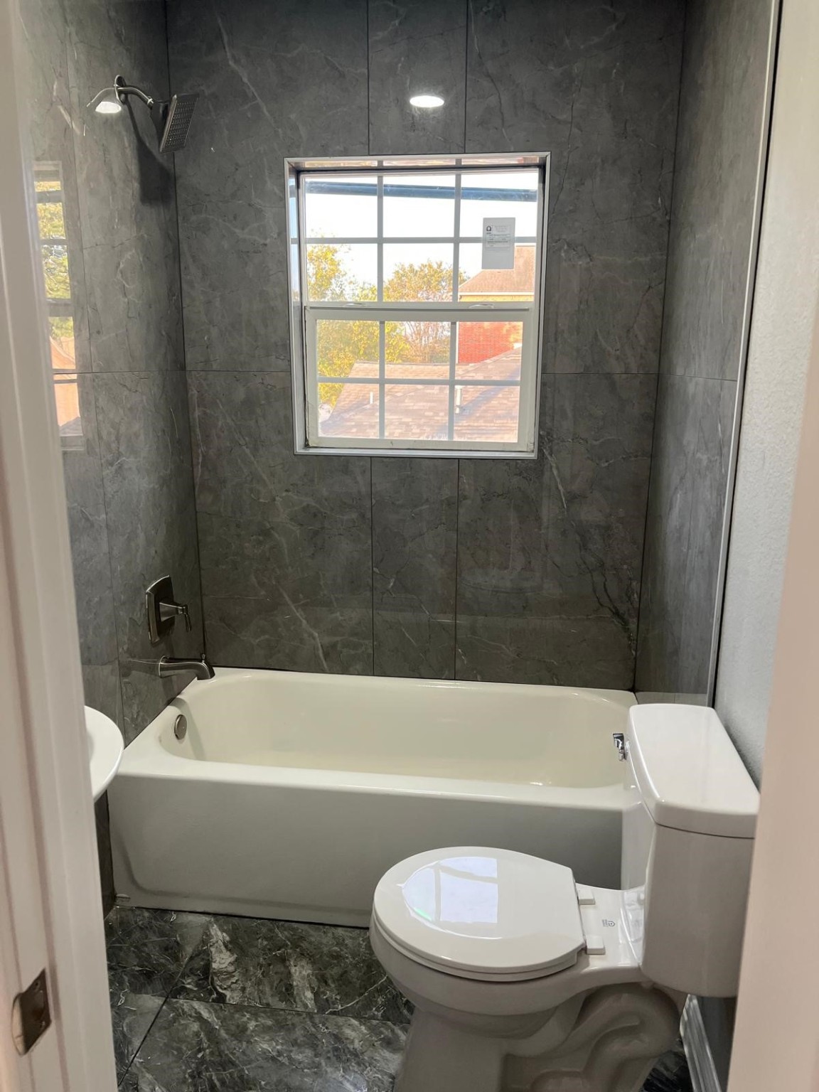 4011 Delano Street, Unit 4 Houston, TX 77004 - Photo 12 of 12 a bathroom with a toilet a sink and bathtub