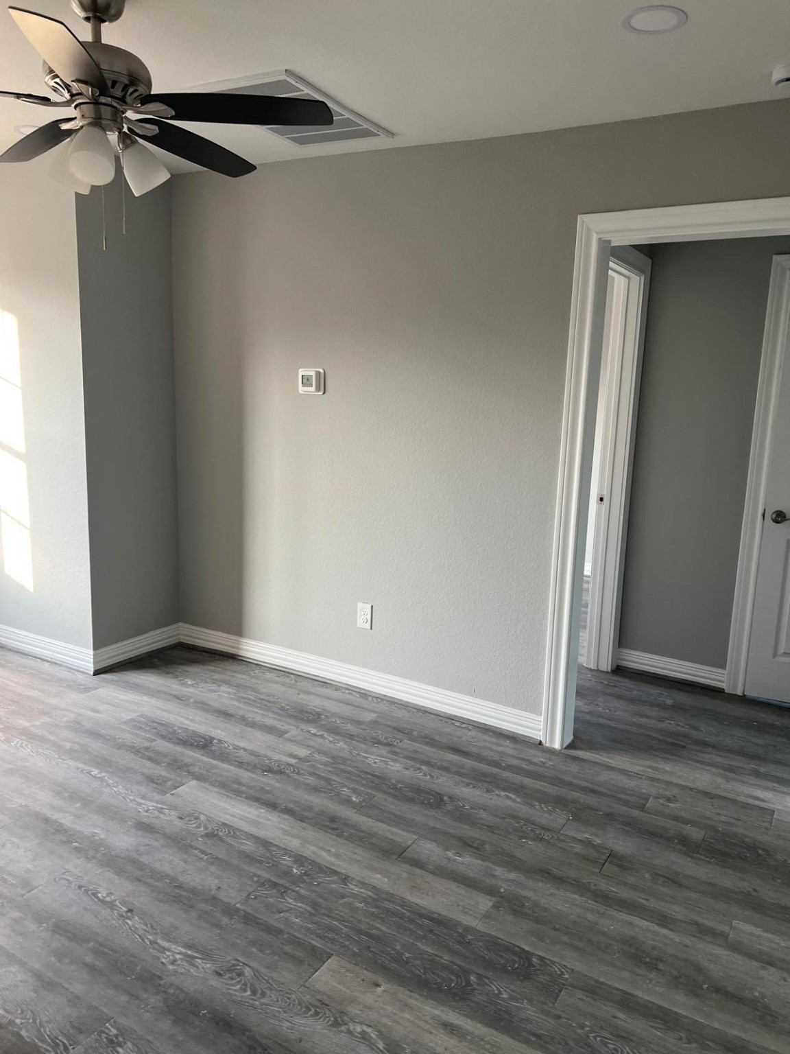 4011 Delano Street, Unit 4 Houston, TX 77004 - Photo 3 of 12 a view of an empty room with wooden floor and a window