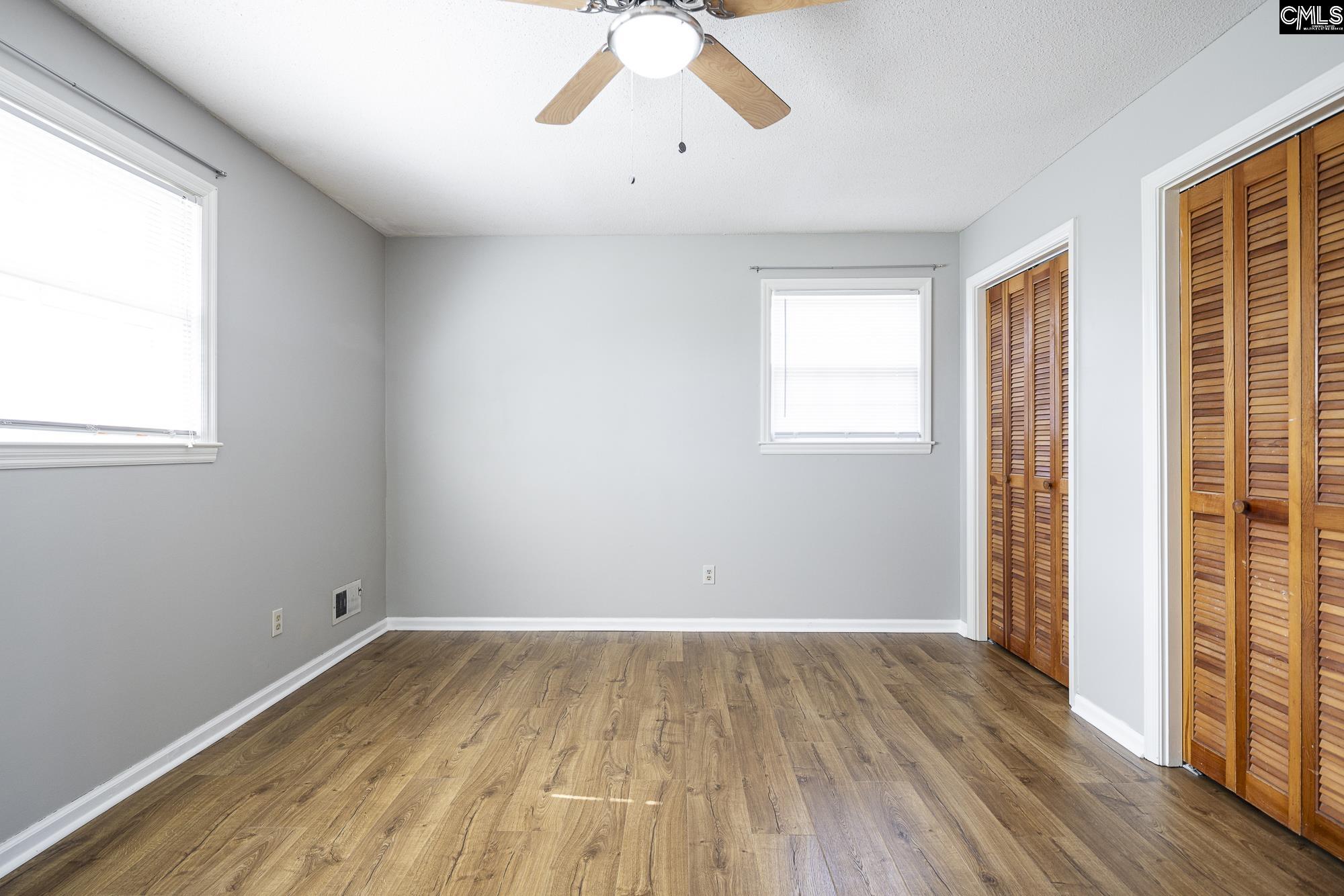 4083 Platt Springs Road West Columbia, SC 29170 - Photo 21 of 35 wooden floor in an empty room with a window