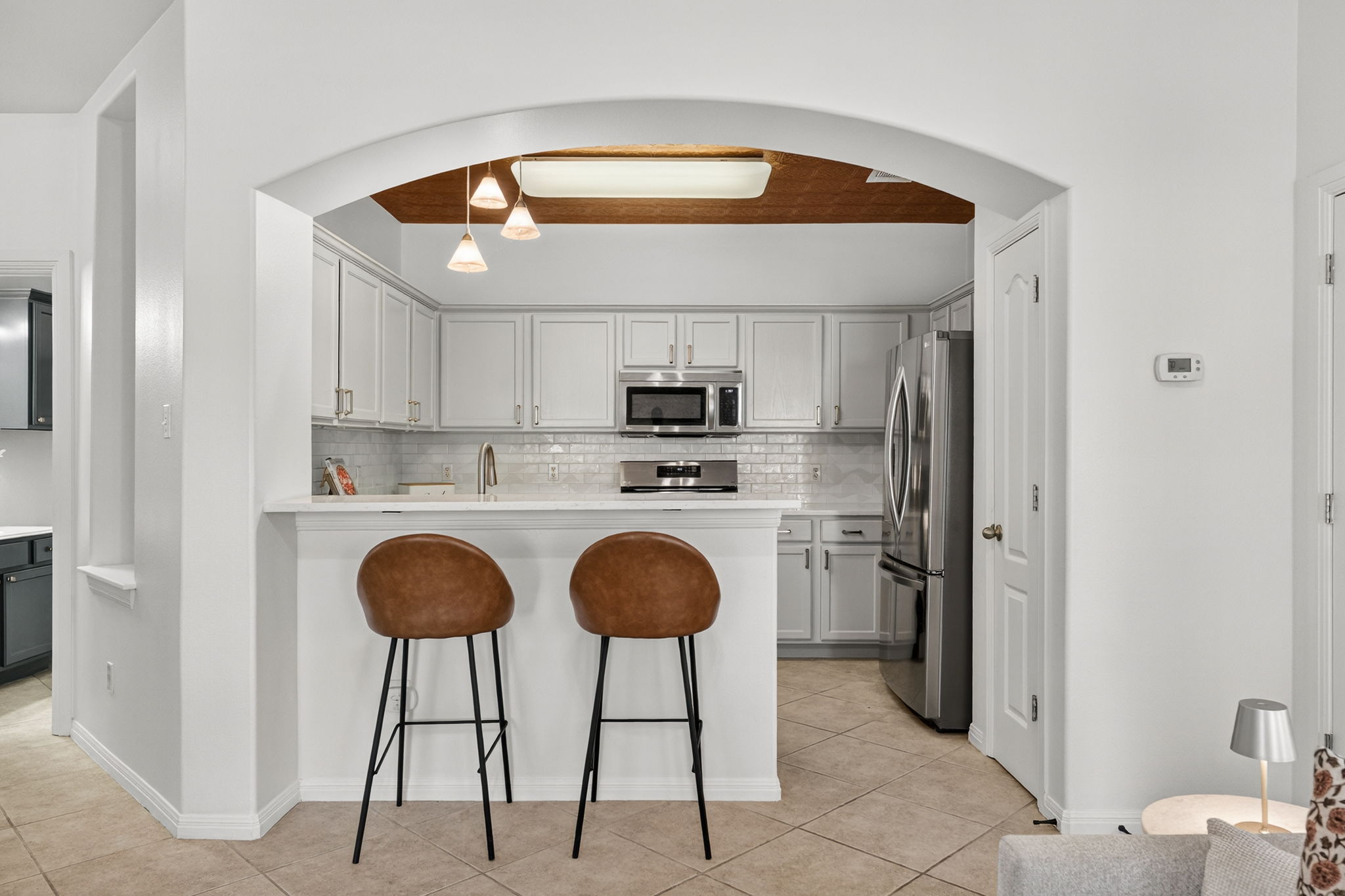 6801 Beckett Road, Unit 114R Austin, TX 78749 - Photo 5 of 21 a kitchen with stainless steel appliances a stove a sink and a refrigerator with wooden floor