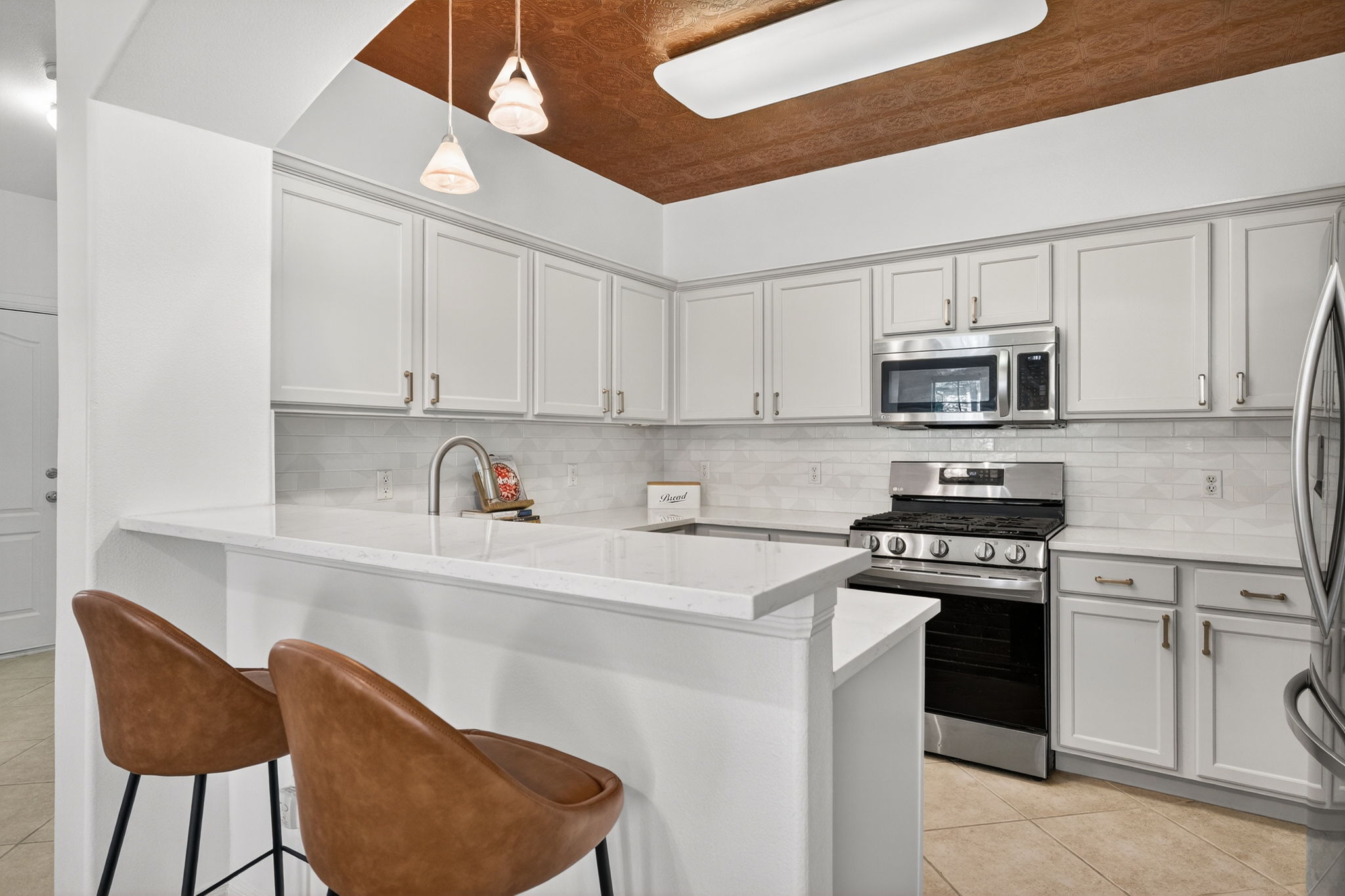 6801 Beckett Road, Unit 114R Austin, TX 78749 - Photo 6 of 21 a kitchen with stainless steel appliances granite countertop a stove a sink dishwasher and a refrigerator