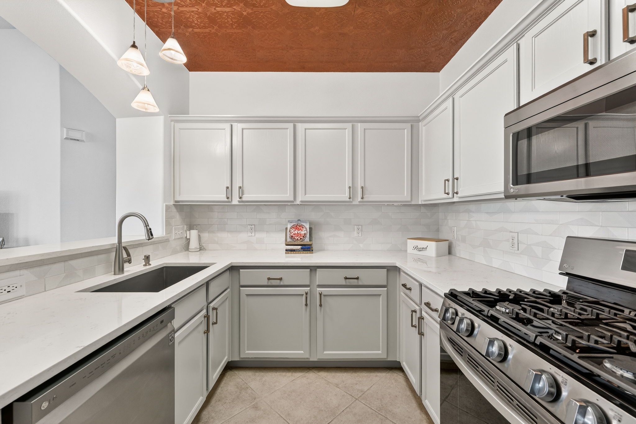 6801 Beckett Road, Unit 114R Austin, TX 78749 - Photo 7 of 21 a kitchen with white cabinets sink and stove top oven