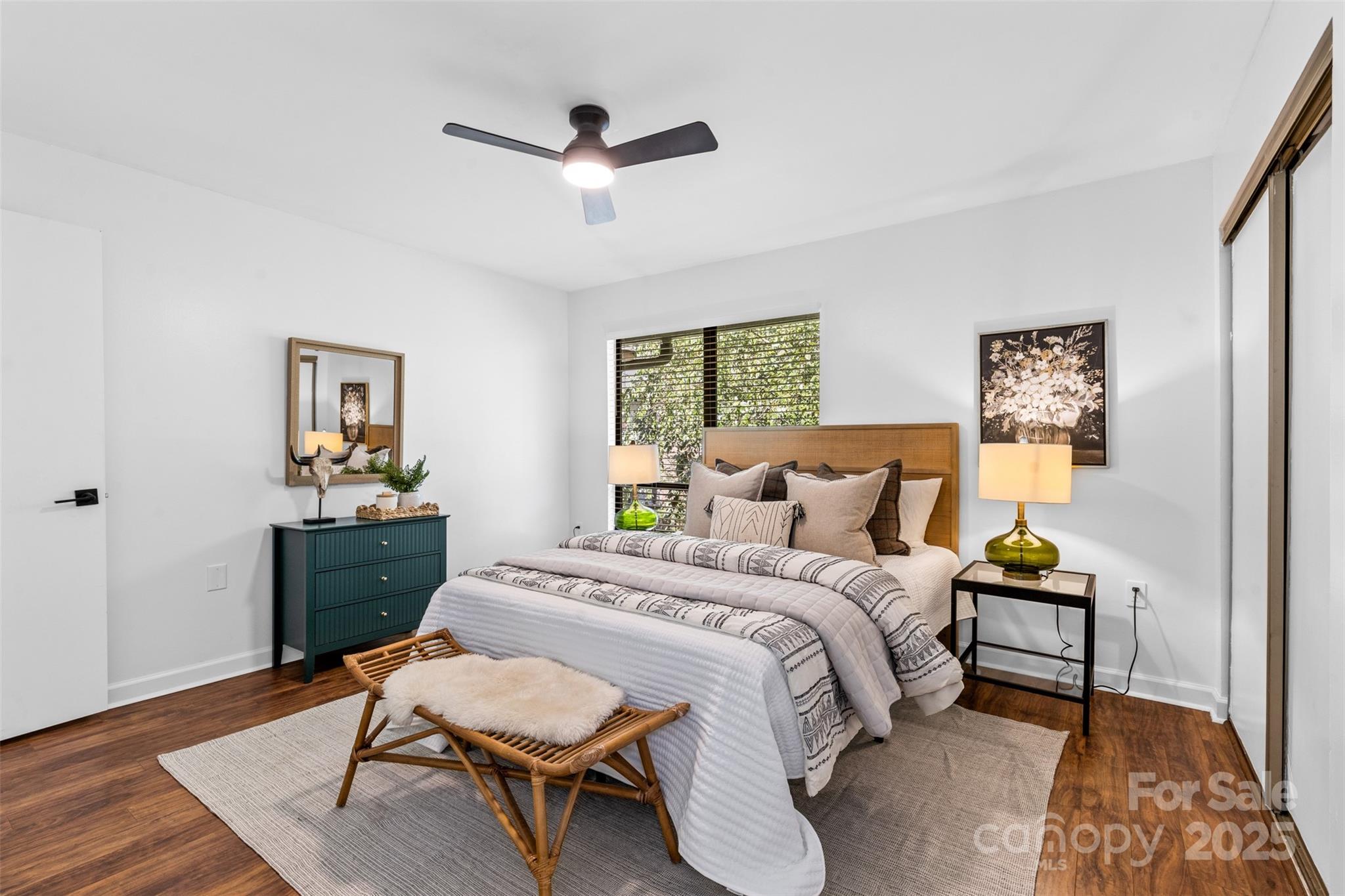 5016 Sardis Road, Unit G Charlotte, NC 28270 - Photo 17 of 24 a bedroom with a bed mirror and a window