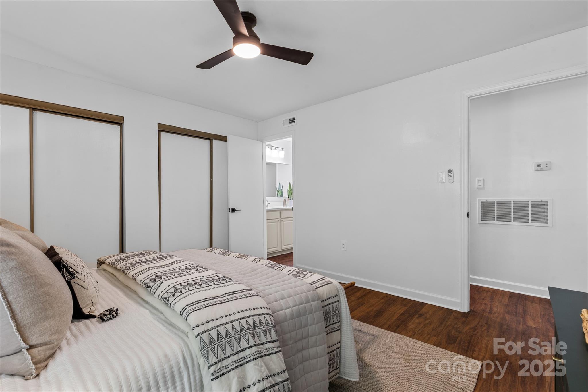 5016 Sardis Road, Unit G Charlotte, NC 28270 - Photo 18 of 24 a bedroom with a large bed and wooden floor