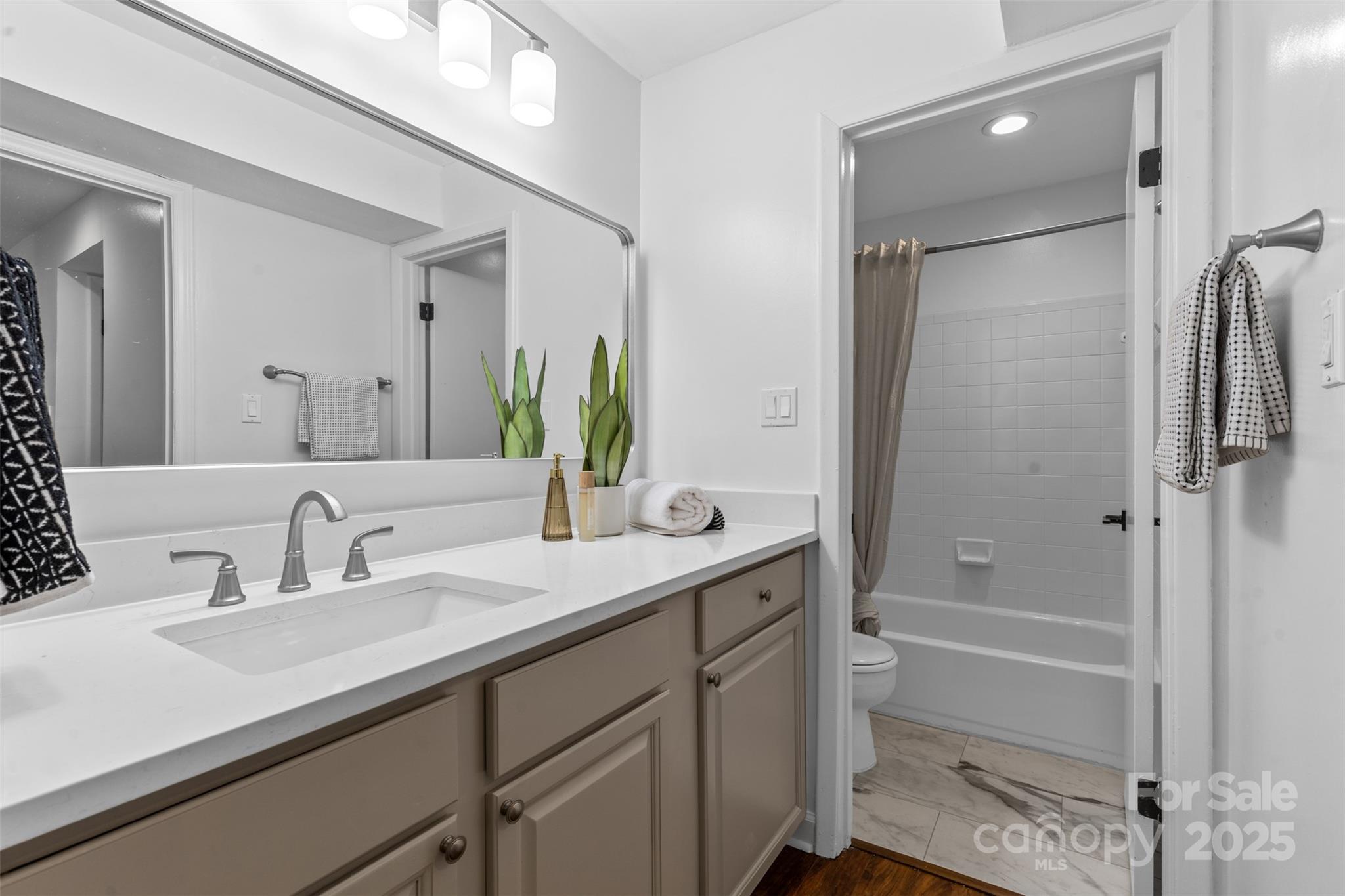 5016 Sardis Road, Unit G Charlotte, NC 28270 - Photo 19 of 24 a bathroom with a shower sink vanity granite and shower