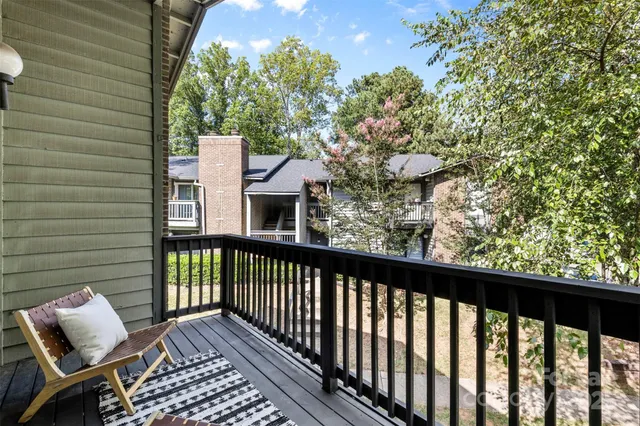 a view of a balcony with wooden floor