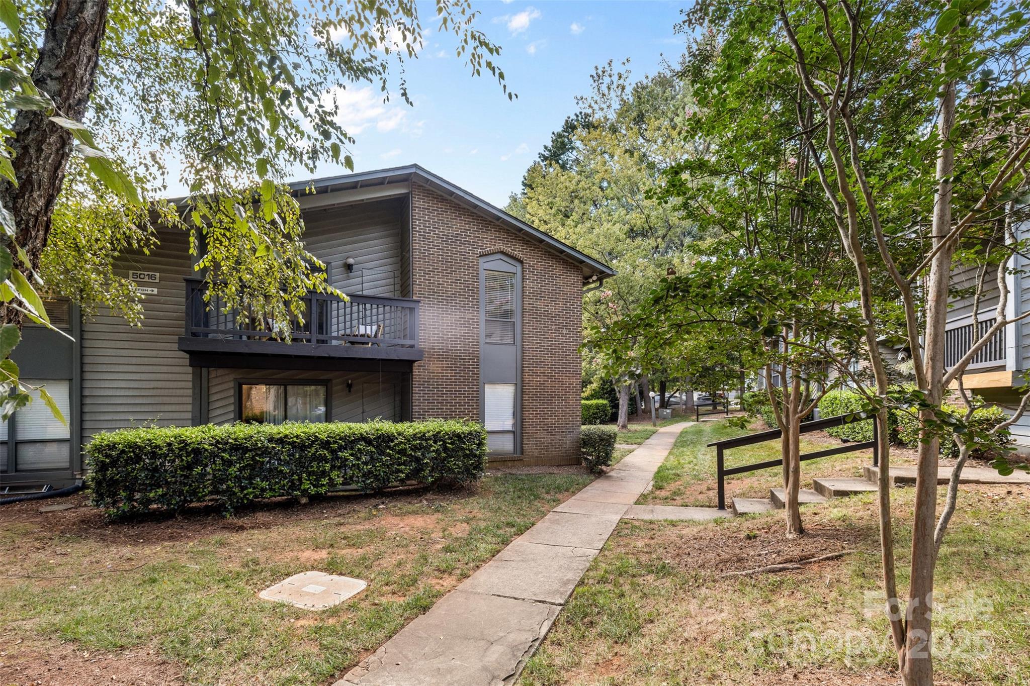5016 Sardis Road, Unit G Charlotte, NC 28270 - Photo 22 of 24 a view of a house with a yard