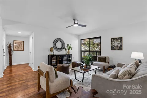 a living room with furniture a window and a fireplace