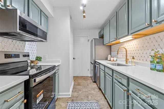 a kitchen with stainless steel appliances granite countertop a sink stove and refrigerator