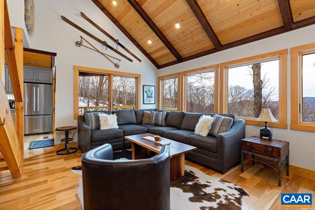 134 Squirrel Tree Lane Roseland, VA 22967 - Photo 18 of 40 a living room with furniture floor to ceiling window and wooden floor